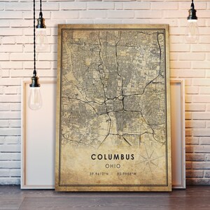 May include: Vintage style map print of Columbus, Ohio. The map is printed on a beige background with black lines and text. The text at the bottom of the map reads "Columbus, Ohio, 39.9612&deg;N - 82.9988&deg;W".
