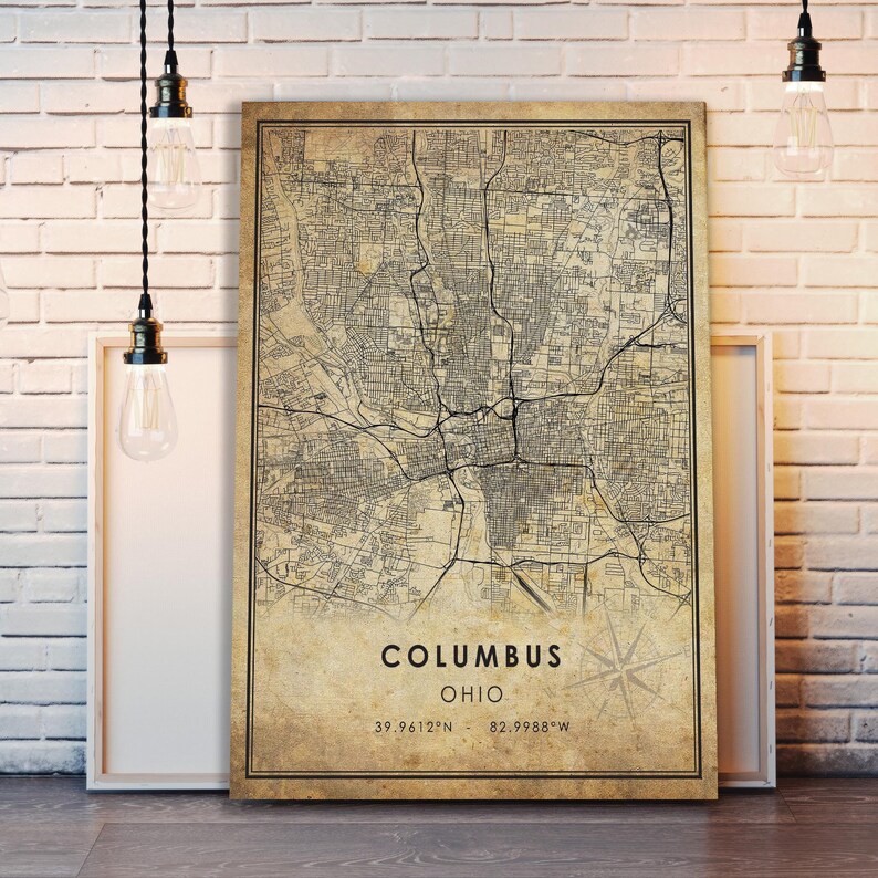 May include: Vintage style map print of Columbus, Ohio. The map is printed on a beige background with black lines and text. The text at the bottom of the map reads "Columbus, Ohio, 39.9612&deg;N - 82.9988&deg;W".