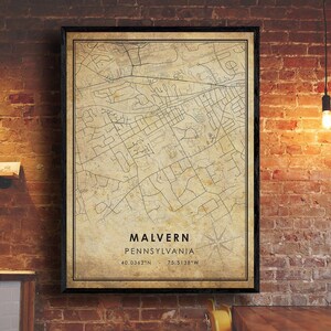 May include: A vintage-style map print of Malvern, Pennsylvania. The map is printed on a beige background with brown lines and text. The text at the bottom reads "Malvern, Pennsylvania 40.0362°N 75.5138°W".