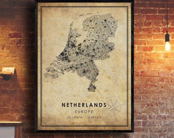 May include: A vintage-style map of the Netherlands, printed on a beige background with a black border. The map shows the country's outline and major cities. The text "Netherlands, Europe, 52.1326°N, 5.2913°E" is printed below the map.