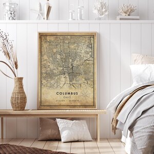 May include: Vintage style map print of Columbus, Ohio with a compass rose and the coordinates 39.9612&deg;N, 82.9988&deg;W. The map is printed on a textured paper with a beige background and black lines.