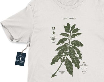 May include: White t-shirt with a green botanical illustration of a coffee plant with the text "Coffea Arabica" printed on the front.