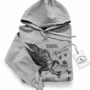 May include: Gray hooded sweatshirt with a black and white illustration of a bird of prey with anatomical details and the text "Osprey Pandion Haliaetus". The tag attached to the sweatshirt reads "Life Shines".