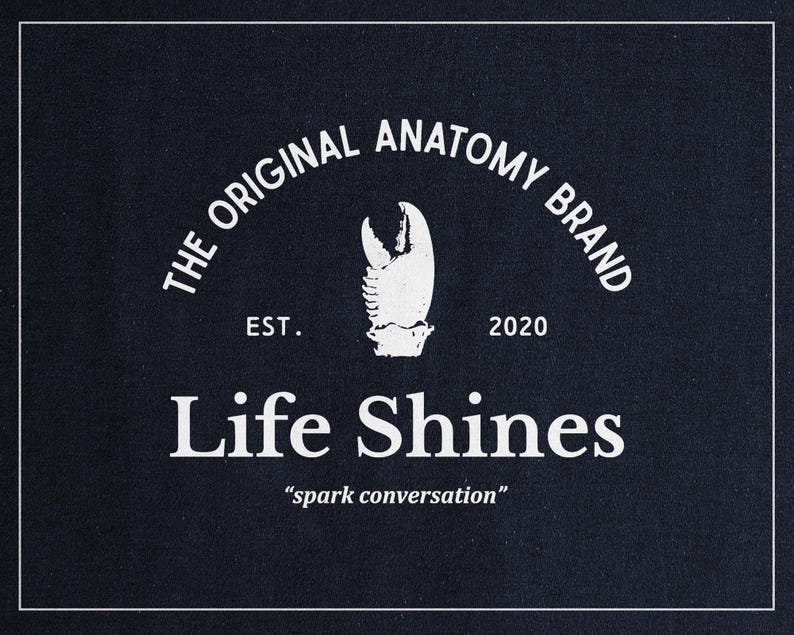 a black shirt with the words life shines printed on it