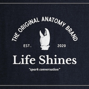 a black shirt with the words life shines printed on it