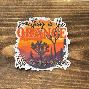 Something in the orange sticker | country song sticker | something tells me we’re not done | orange | sticker for car | country