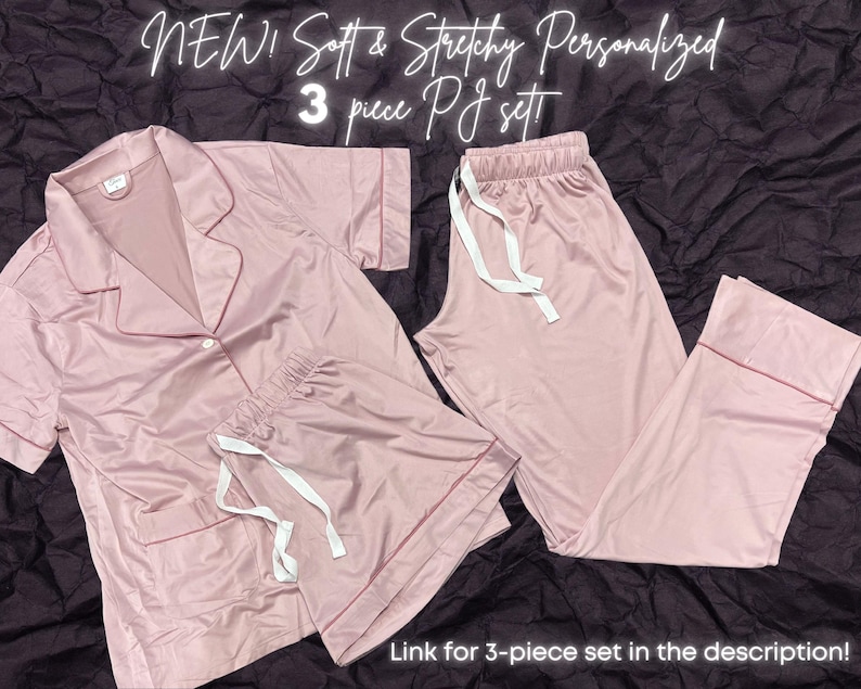 May include: A three-piece pajama set in a soft pink color. The set includes a long-sleeved shirt with a collar, shorts, and long pants. The fabric appears to be soft and stretchy. "NEW! Soft & Stretchy Personalized 3 piece PJ set" is written in white text on a pink background.