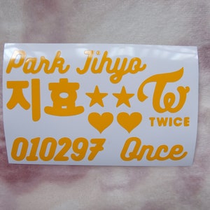 May include: A white sticker sheet with orange text and graphics. The text includes "Park Jihyo", Korean characters, stars, hearts, the word "TWICE", the numbers "010297", and the word "Once".