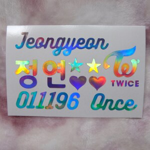 May include: A holographic sticker featuring the name "Jeongyeon" in a stylized font, along with Korean characters, stars, hearts, and the word "TWICE". The sticker also includes the numbers "011196" and the word "Once".