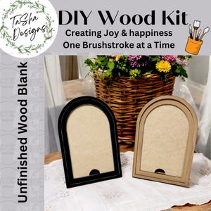 May include: Two unfinished wood picture frames with arched tops. The frames are black and brown and are sitting on a white tablecloth. The text "DIY Wood Kit" is at the top of the image. The text "Creating Joy & happiness One Brushstroke at a Time" is below the title.