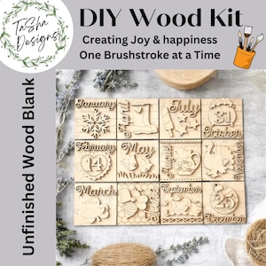 May include: A DIY wood kit with unfinished wood blanks. The kit includes twelve wooden squares, each representing a month with laser-cut designs and text. The text includes "January", "February", "March", "April", "May", "June", "July", "August", "September", "October", "November", and "December".