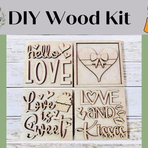 May include: DIY wood craft kit with four unfinished wooden signs featuring Valentine's Day themed sayings: "hello love", "love is sweet", "love and", and "kisses".