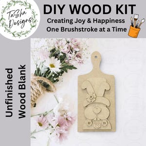 May include: A DIY wood kit with the text "DIY WOOD KIT Creating Joy & Happiness One Brushstroke at a Time." The kit includes an unfinished wood blank in the shape of a bunny with a flower and buttons.