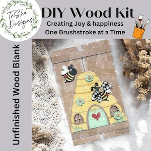 May include: DIY wood craft kit featuring a beehive with a heart-shaped door and two bees. The kit includes unfinished wood pieces and instructions for creating a beehive-themed home decor piece. The text on the image reads "DIY Wood Kit Creating Joy & happiness One Brushstroke at a Time Unfinished Wood Blank".