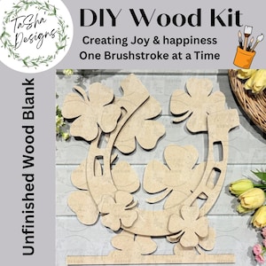 May include: A DIY wood kit featuring an unfinished wood blank in the shape of a horseshoe and shamrocks. The kit includes the text "DIY Wood Kit" and "Creating Joy & happiness One Brushstroke at a Time". The design is perfect for painting.