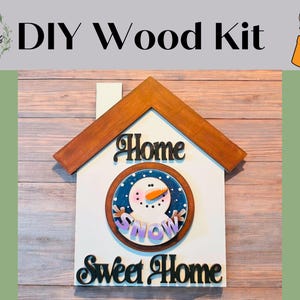 May include: DIY wood kit to create a wooden home sign with a snowman and the words "Home Sweet Home".
