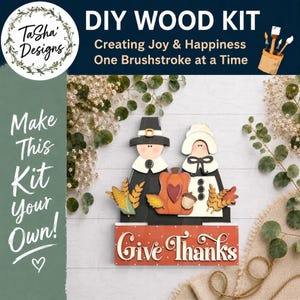 May include: DIY wood kit featuring a Thanksgiving theme. The kit includes wooden cutouts of a pilgrim couple, a pumpkin, and fall foliage. The words "Give Thanks" are displayed on a red sign. The kit is designed for creating joy and happiness.