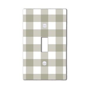 May include: A light switch cover with a white and gray gingham pattern.