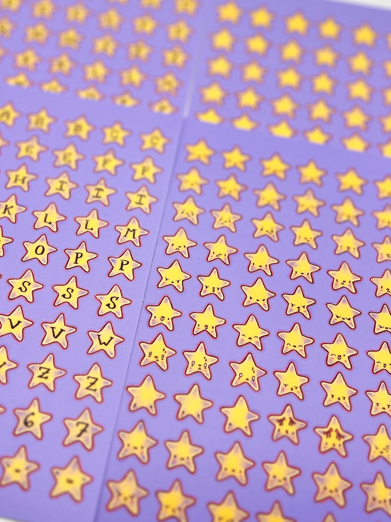 May include: Sheets of purple stickers featuring yellow star shapes with smiling faces and letters of the alphabet. The stickers have a red outline. Some stickers have numbers. The stickers are arranged in rows and columns.