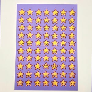May include: A sheet of stickers featuring yellow cartoon stars with smiling faces and red outlines. The stars are arranged in a grid pattern on a purple background. The stickers are on a white background.