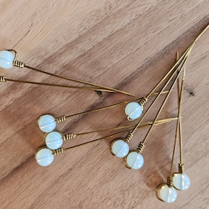 Medieval brass needle, giving needle, garment pin with moonstone head