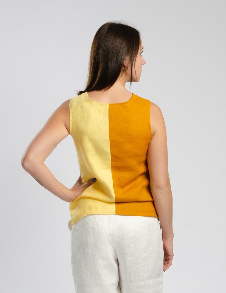 May include: A sleeveless top with a yellow and orange color block design. The top is made of a linen fabric and has a relaxed fit.