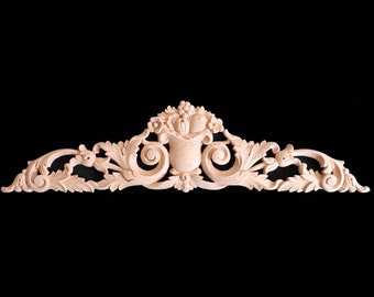 May include: A carved wooden decorative piece with a floral design and a central motif of a vase with flowers. The piece is light brown in color and has a delicate, intricate design.