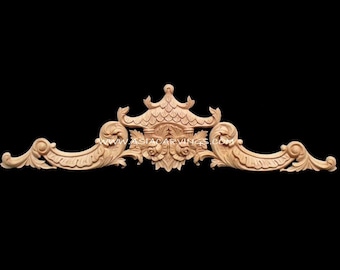 May include: A wooden carved ornament with a pagoda-like design in the center, flanked by two symmetrical scrolls. The ornament is made of light brown wood and has a natural finish.