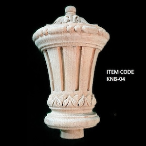 May include: A wooden finial with a fluted design and intricate carvings. The finial is unfinished and has a natural wood colour. ITEM CODE KNB-04