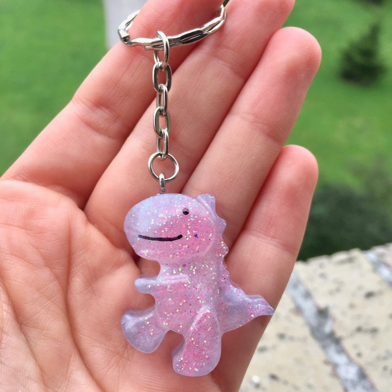 Personalized dinosaur keychain made with epoxy resin. Pink | Etsy