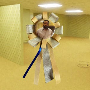 May include: A circular pinback button featuring a photograph of a person with a beard wearing a tan shirt, centred on a decorative rosette made of metallic gold and silver ribbons with a single thin blue ribbon tail hanging downwards.