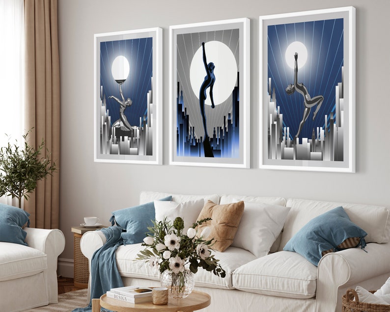 May include: Three framed art prints with a blue and silver color scheme. Each print features a stylized silhouette of a woman dancing against a backdrop of a city skyline and a large moon.