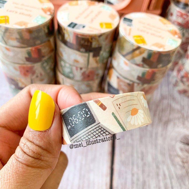 May include: Decorative washi tape rolls with a beige background and a variety of designs, including a computer screen displaying "06:00", daisies, and stationery. The rolls are stacked, and the text "Let's study" is visible on some.