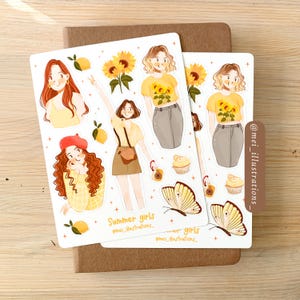 May include: Two sticker sheets featuring illustrations of girls, sunflowers, lemons, butterflies, and cupcakes. The stickers have a summer theme, with the text "Summer girls" and the artist's Instagram handle. The stickers are on a brown notebook.
