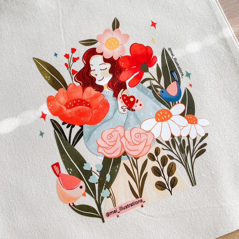 May include: Illustration of a woman with red hair, wearing a light blue sweater, surrounded by red, pink, and white flowers and birds. The birds are pink and blue. The text "@mei_illustrations_" is visible.