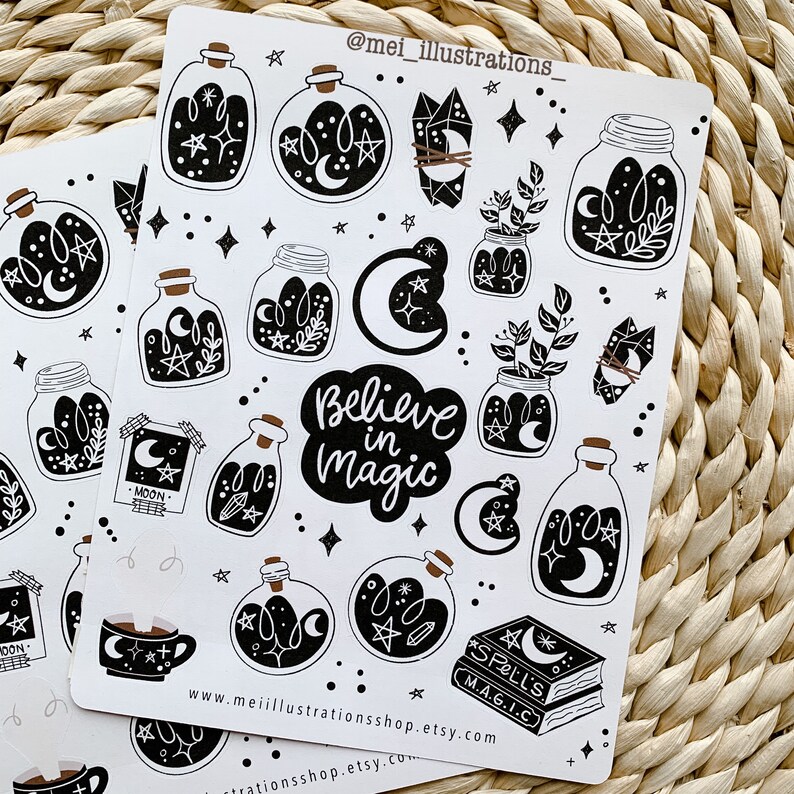 May include: Two sheets of stickers with a witchy theme. The stickers feature black and white illustrations of potion bottles, crystals, moons, stars, plants, a coffee cup, and a spell book. The phrase "Believe in Magic" is also included.