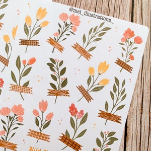 May include: Sheets of floral stickers featuring various flower and leaf designs in shades of peach, yellow, and green. The floral elements are affixed with brown tape. The text "@mei_illustrations_" is visible at the top. The stickers are on a white background.