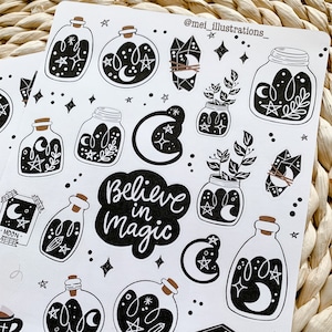 May include: Sheet of black and white stickers featuring celestial and botanical illustrations. Designs include jars with moons, stars, and plants, crystals, and the phrase "Believe in Magic". The stickers have a whimsical, mystical theme.