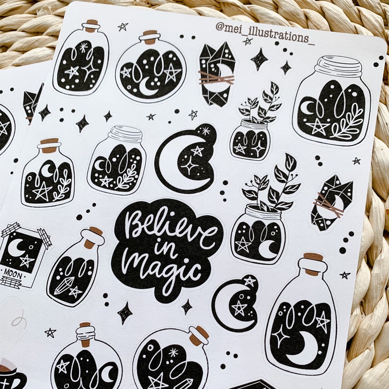 May include: Sheet of black and white stickers featuring celestial and botanical illustrations. Designs include jars with moons, stars, and plants, crystals, and the phrase "Believe in Magic". The stickers have a whimsical, mystical theme.