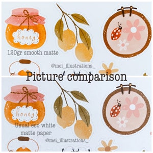 May include: A comparison of two sticker designs. One features a honey jar with the word "honey", a lemon branch, and a floral embroidery hoop with a ladybug. The other design is similar, with the text "120gr smooth matte" and "Usual eco white matte paper".