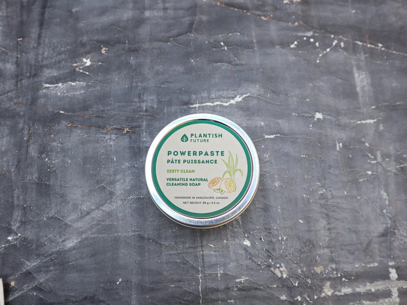 May include: A round metal tin of Plantish Future Powerpaste cleaning soap. The label is green and white with text reading Powerpaste, P&acirc;te Puissance, Zesty Clean, Versatile Natural Cleaning Soap, and a net weight of 89 g / 3.5 oz.