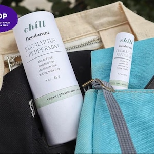 May include: Two white cylindrical deodorant tubes labelled Chill Eucalyptus + Peppermint. The larger tube is 85 g and the smaller tube is 56 g. Both feature text stating alcohol free, paraben free, aluminium free, baking soda free, vegan, and plastic-free.