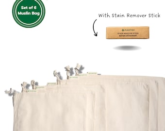 May include: Set of six organic cotton muslin bags with drawstring closures. The bags are stacked on top of each other. The bags are white and have a green label that says "Plantish". The image also includes a small brown box with a green label that says "Plantish Stain Remover Stick Baton Détachant".