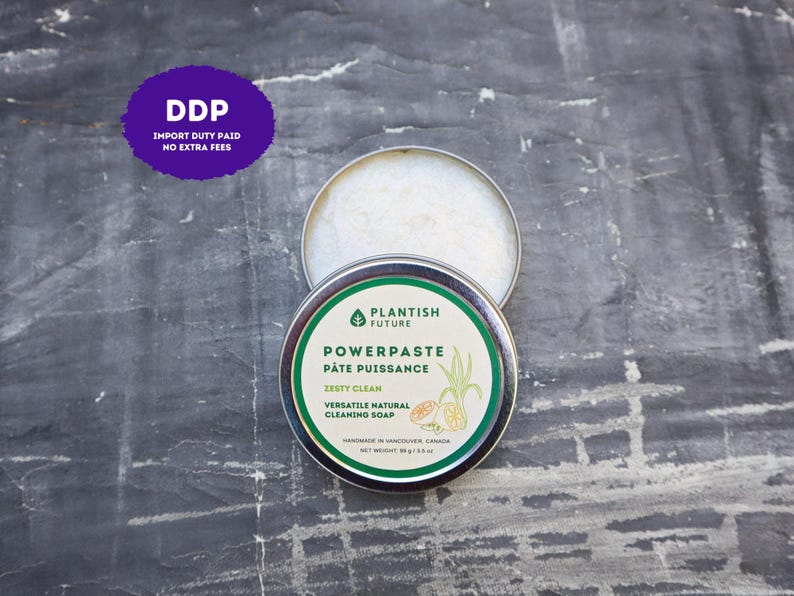 May include: A round metal tin containing Plantish Future Powerpaste cleaning soap. The label features green text, a leaf icon, and citrus illustrations. It states Zesty Clean, Versatile Natural Cleaning Soap, and Net Weight 98 g / 3.5 oz.