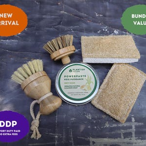 May include: A cleaning set featuring two bamboo brushes with light-colored bristles, one with a rope loop, two rectangular fibrous sponges, and a round metal tin of Plantish Future Powerpaste cleaning soap with a net weight of 90 g / 3.2 oz.