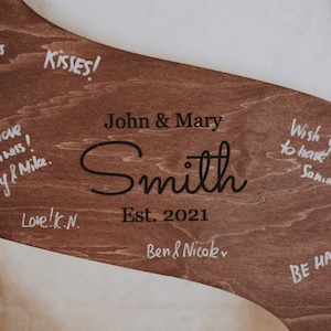 The natural wood finish adds a touch of warmth to your wedding decor, while the personalized touch allows you to infuse your own style into this special keepsake.