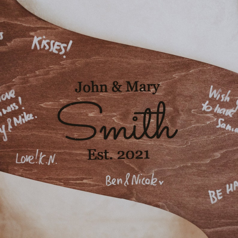 The natural wood finish adds a touch of warmth to your wedding decor, while the personalized touch allows you to infuse your own style into this special keepsake.