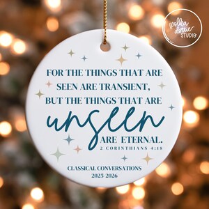 May include: White ceramic Christmas ornament with gold string, featuring the quote "For the things that are seen are transient, but the things that are unseen are eternal." The ornament also includes the text "2 Corinthians 4:18" and "Classical Conversations 2025-2026".