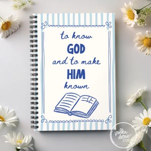May include: Spiral-bound notebook with a light blue striped cover and the text "to know GOD and to make HIM known" in blue. The design includes a drawing of an open book. White daisies are arranged around the notebook.