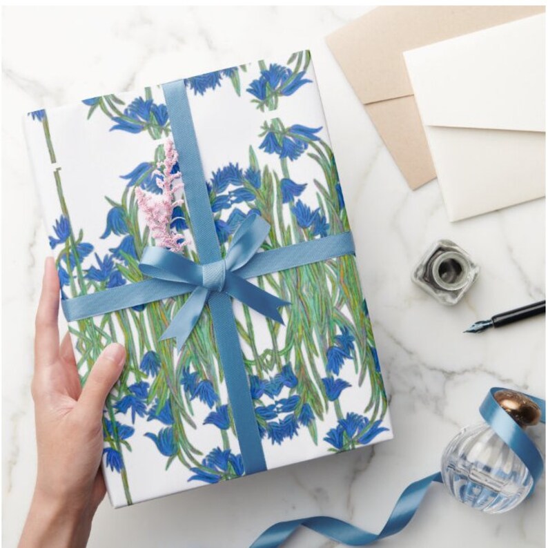 Shown above: the tissue paper wrapped on a medium sized rectangular gift box. It has a blue satin ribbon tied in a bow (not included).